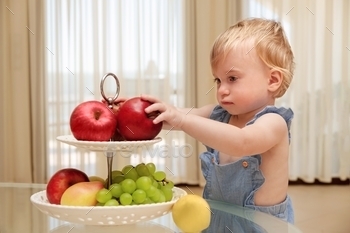 Baby girl eating fruits