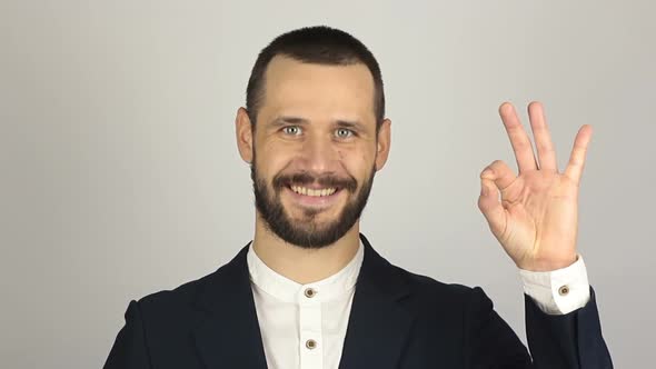 Young Handsome Businessman Says Ok and Shows Gesture Ok