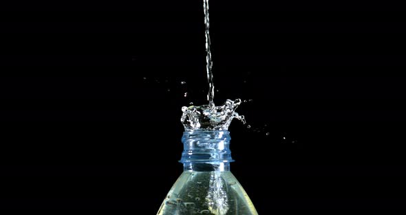 Water Exploding and Splashing on Bottle against Black Background, Slow motion 4K alt