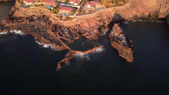 View of coastal town next to the sea drone aerial bird view, Puerto de Santiago, Los Gigantes, Tener alt