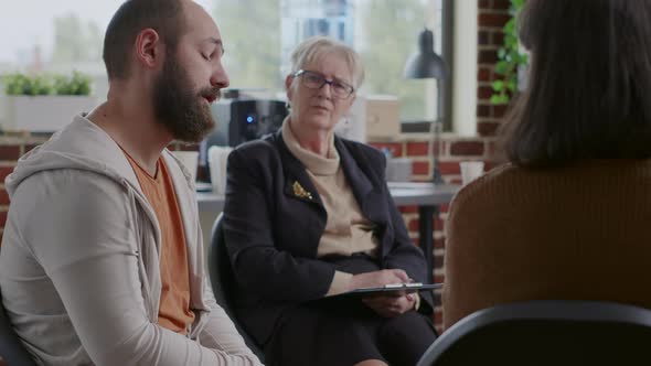Man in Despair Sharing Sad Story About Alcohol Addiction in Front of People at Aa Group Therapy alt