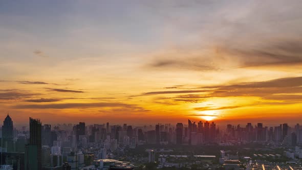 Sun rise over Bangkok business district, night to day - Time Lapse