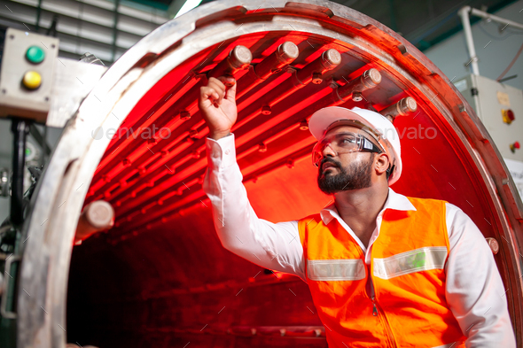 professional technician engineer with safety hard hat working in industrial factory.