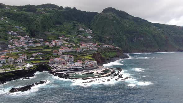 Flying over Porto Moniz town in northern Maderia, Portugal alt