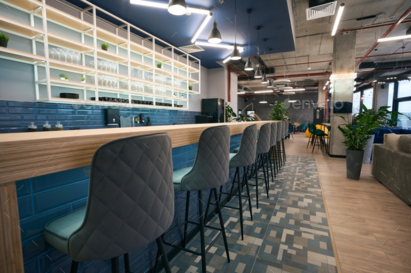 Creative zoning in coworking space, stylish bar area, clean empty space