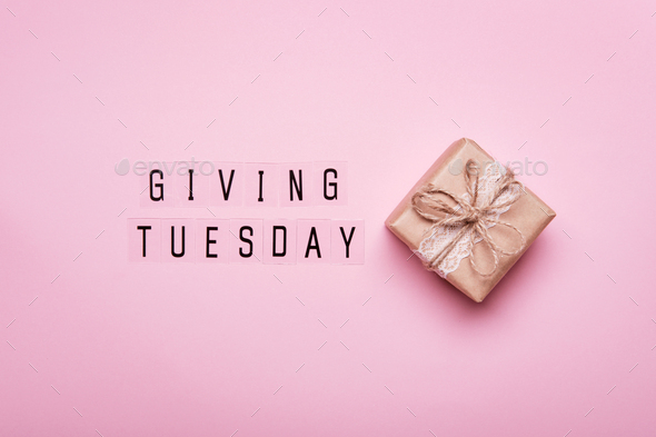 Giving Tuesday. Global day of charitable giving after Black Friday shopping day. Paper gift box