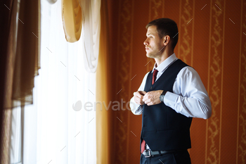 Luxury groom in suit. Businessman. Morning Groom Fees. The beginning of wedding day. Men's fashion.
