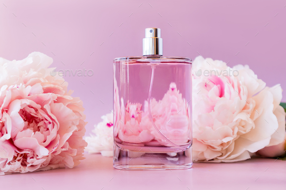 Beautiful bottle of women's perfume on a pink background with a chic ...