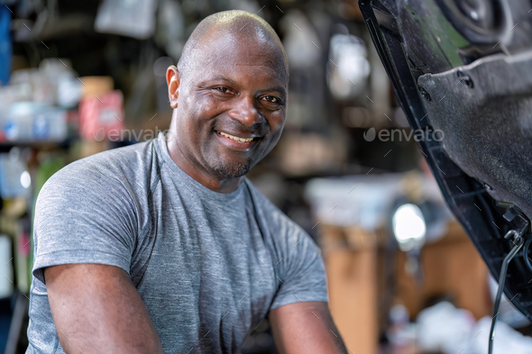 Mechanics man standing smiling use wrench tighten