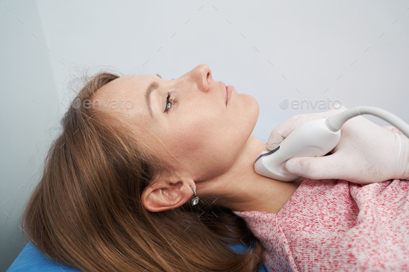 Close up photo of young woman of the thyroid gland screening