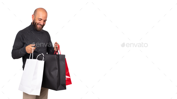 man looks inside shopping bag with satisfaction. Horizontal banner.white background. Copy space.