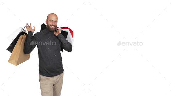 Horizontal banner of man looking at camera carrying shopping bags. White background. Copy space.