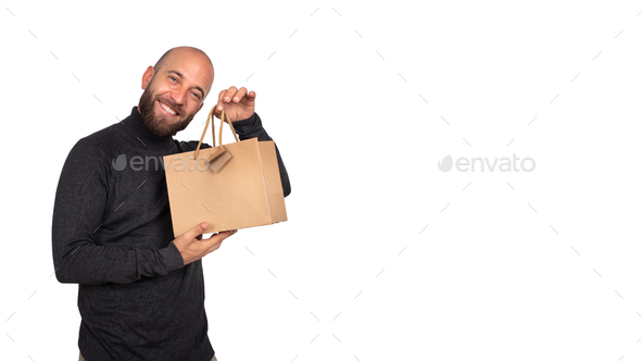 man looking at camera shows brown gift shopping bag.hite background.Horizontal banner.Copy space