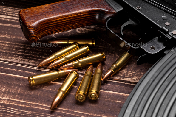 Bullets and Kalashnikov assault rifle on wooden background - Stock Photo - Images