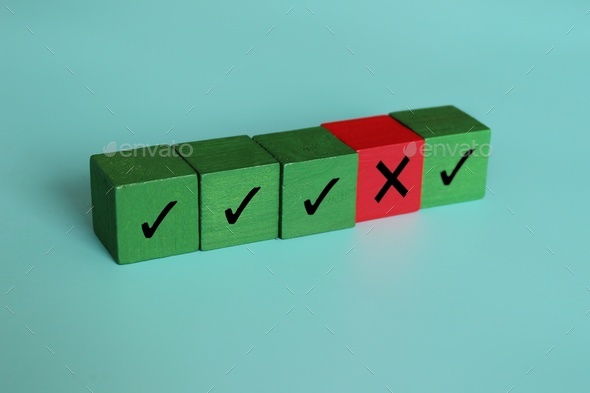 Wooden cubes with right and wrong icon.