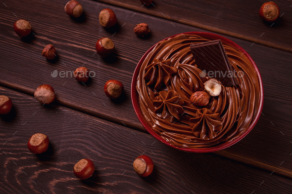 Chocolate nut paste, mousse, pasta, in a cup, on a wooden table, top view, selective focus,