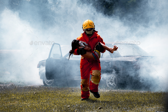 Fireman wearing safety uniform help car crash accident with axe for rescue victim life on fire and t