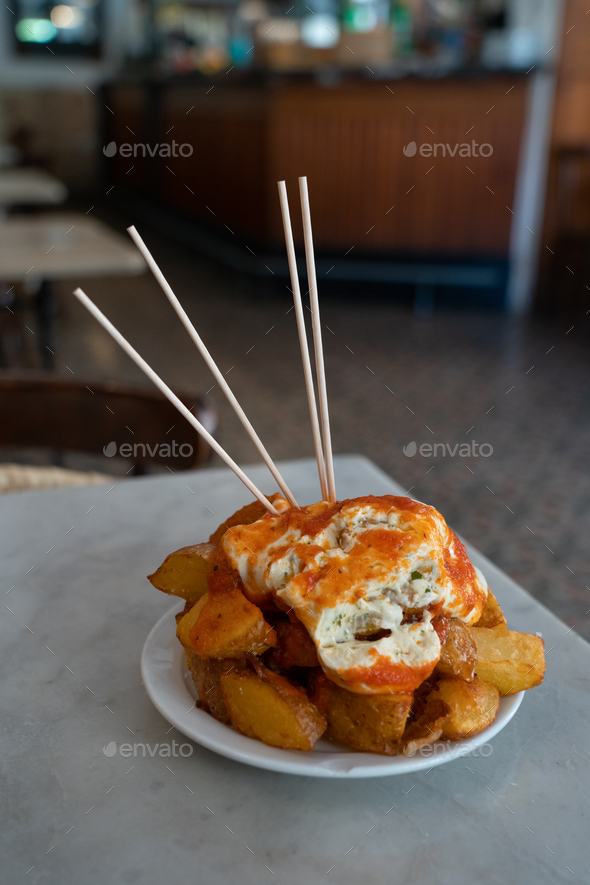Patatas Bravas, traditional Spanish tapas, baked potatoes with spicy
