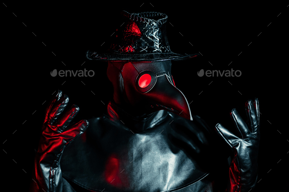 Portrait of plague doctor with crow-like mask isolated on black background.