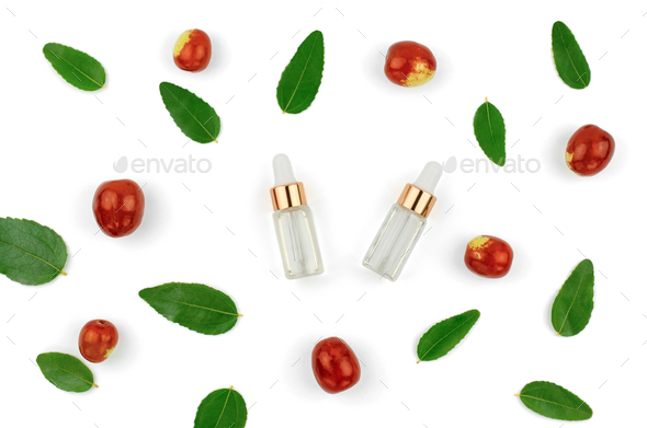 Chinese date fruit and oil. Jojoba oil in a transparent bottle with a dropper and fresh jojoba fruit