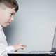 School child looking at computer over gray background - PhotoDune Item for Sale