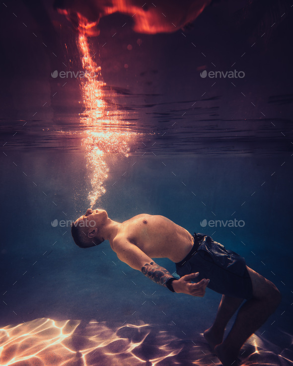 Man breathing fire underwater Stock Photo by Tonkpils PhotoDune
