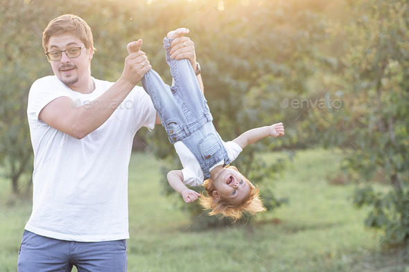 dad holds daughter in his arms and hugs Stock Photo by lulu8206 | PhotoDune