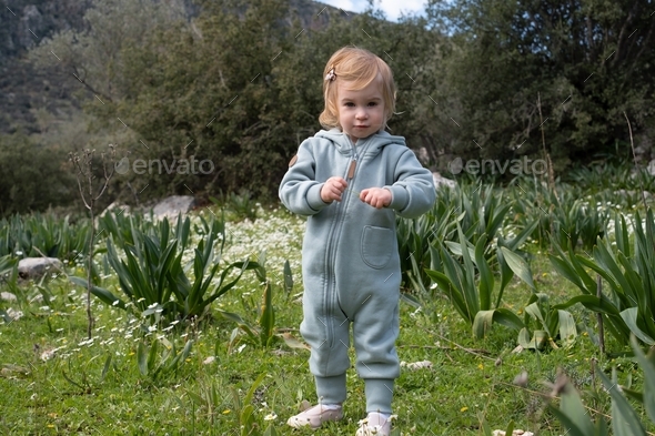Baby girl in green field