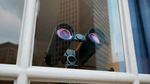 Binoculars in a window. Spying technology. Spy gear. Observation equipment. alt