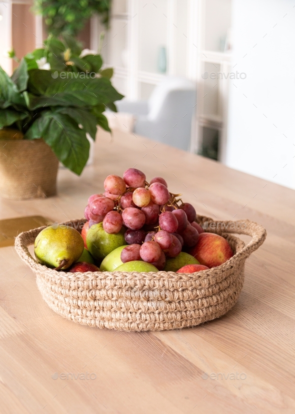jute basket with grapes, pears and apples