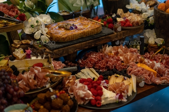 Crackers and berries on a grazing table of food at a party, grazing table of antipasto food