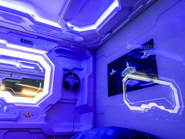 Interior of futuristic Capsule hotel. Inside capsule: sleeping place, control panels, head phones