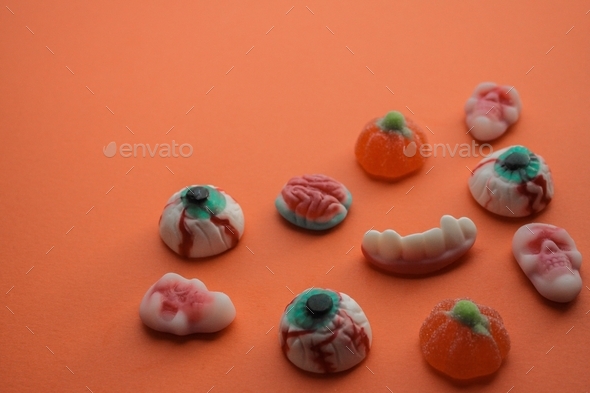 Halloween! Jelly candies in the form of eyes, brains, skulls, teeth with fangs, pumpkins. Copy space