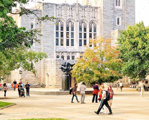 The University - College students walk around campus on a busy morning.