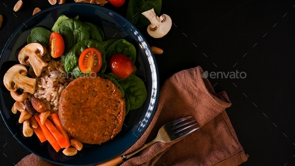 Plant-based food concept. Brown rice with vegan protein burger meat and fresh vegetables