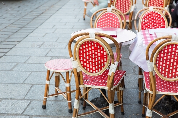 Red bistro chairs outside a cafe in Paris