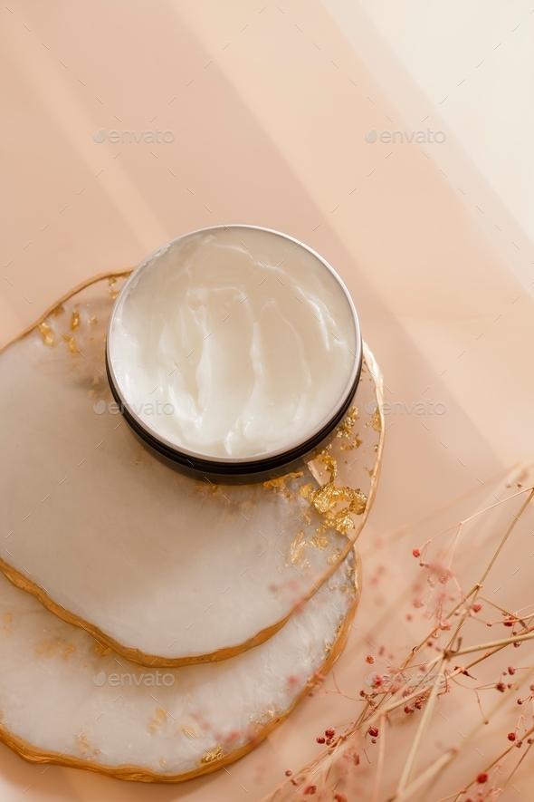 Cosmetic cream open jar with on pastel background. Beauty product still life commercial