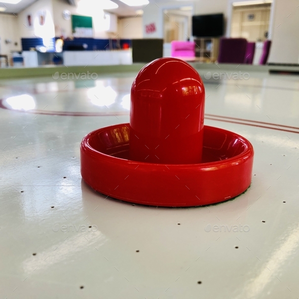 Air hockey game table with red striker Stock Photo by betterxtogether