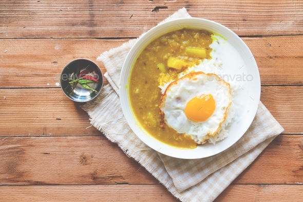 Dal bhat on wooden pallet background served with fried egg