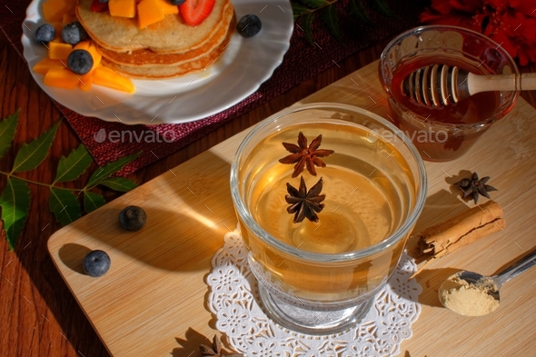 Anise tea served in a glass. Anise tea to accompany breakfast of hotcakes.