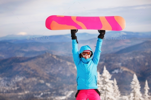 Snowboarder holds the board up raise.