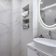 White bathroom interior with marble tiles on the walls - PhotoDune Item for Sale