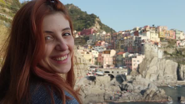 Young Girl Looks at the Landscape in Manarola City of the Five Lands alt