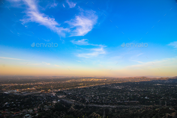 The Sun rising above Los Angeles. Morning sunlight on city under blue sky.
