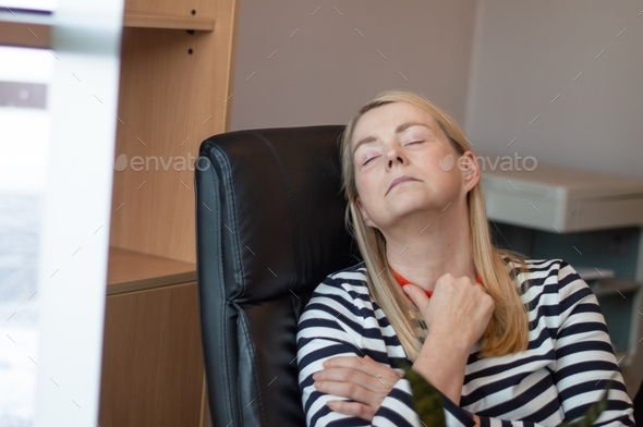Woman resting in the office. Woman fallen asleep in an office chair