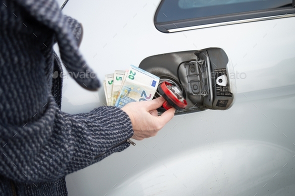 Woman preparing money for filling the tank. Gas price rise concept