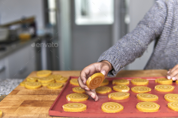 elementary age boy making cookies in wintertime - Stock Photo - Images