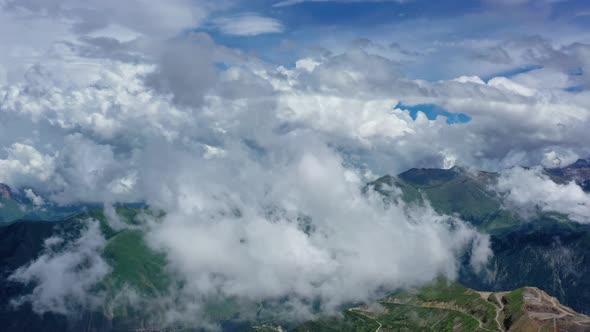 Caucasus Mountains and Town Under Clouds alt