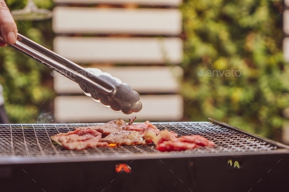 Close up view of pieces of sliced beef on charcoal grill at Outdoor party. outdoor recreation.