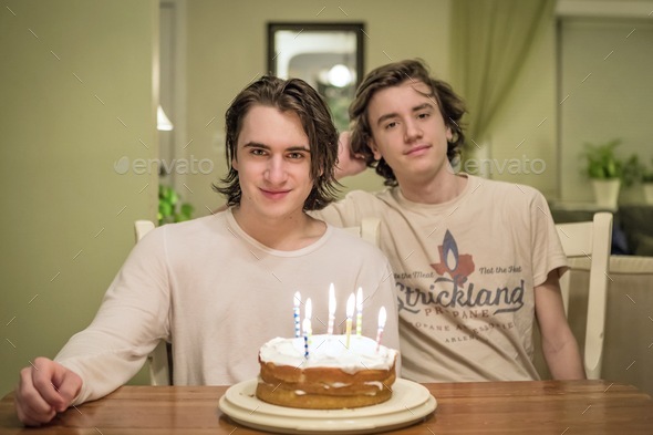 Brothers sharing a birthday cake